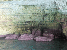 Purple rocks in one of the Crystal Caves at the north coast of Comino, viewed from the Luzzu Cruises tour boat from Comino to Malta