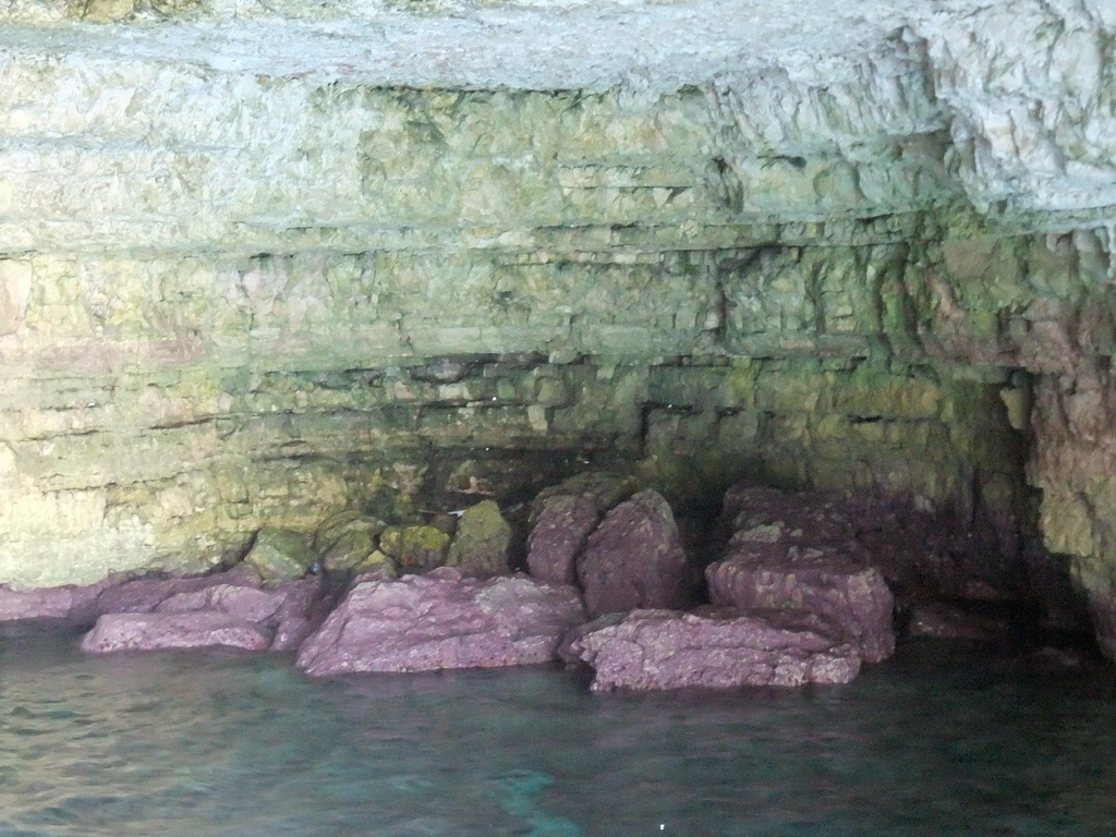 Purple rocks in one of the Crystal Caves at the north coast of Comino, viewed from the Luzzu Cruises tour boat from Comino to Malta