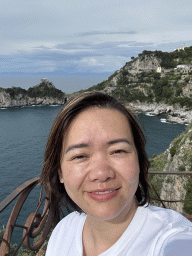 Miaomiao at the parking lot of the Grotta dello Smeraldo cave, with a view on the Torre Capo di Conca tower, the west side of town with the Chiesa San Pancrazio Martire church and the Tyrrhenian Sea
