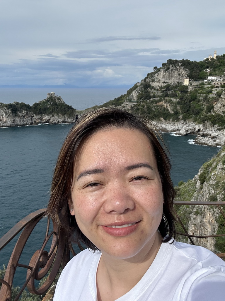 Miaomiao at the parking lot of the Grotta dello Smeraldo cave, with a view on the Torre Capo di Conca tower, the west side of town with the Chiesa San Pancrazio Martire church and the Tyrrhenian Sea