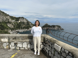Miaomiao at the parking lot of the Grotta dello Smeraldo cave, with a view on the Torre Capo di Conca tower, the west side of town with the Chiesa San Pancrazio Martire church and the Tyrrhenian Sea