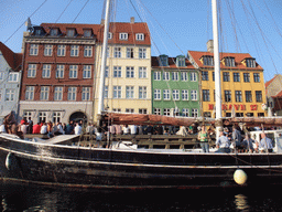 Boat, houses and restaurants at the north side of the Nyhavn harbour, viewed from the DFDS Canal Tours boat