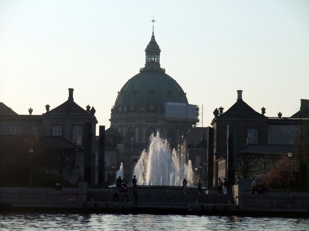 Fountain at the Amaliehaven garden of the Amalienborg Palace, and the dome of the Frederik`s Church, viewed from the DFDS Canal Tours boat