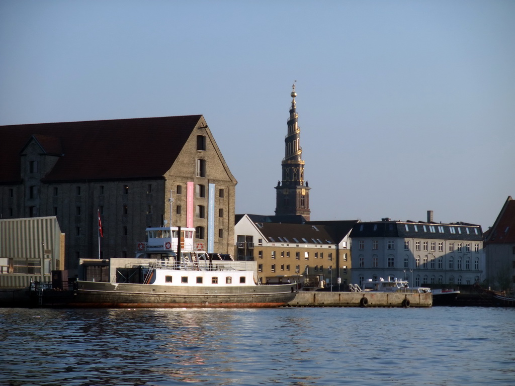 The North Atlantic House (Nordatlantens Brygge) with the Noma restaurant, and the tower of the Church of Our Saviour (Vor Frelsers Kirke), viewed from the DFDS Canal Tours boat