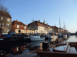 Boats and houses at the Christianshavn Canal, and the tower of the Church of Our Saviour, viewed from the DFDS Canal Tours boat