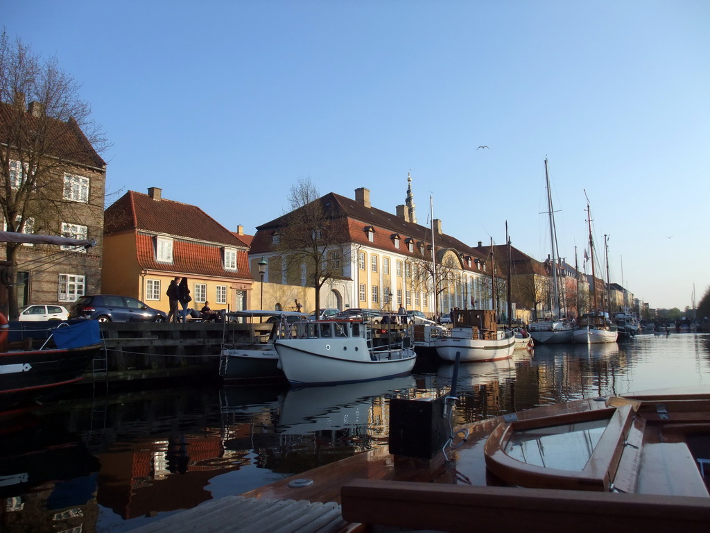 Boats and houses at the Christianshavn Canal, and the tower of the Church of Our Saviour, viewed from the DFDS Canal Tours boat