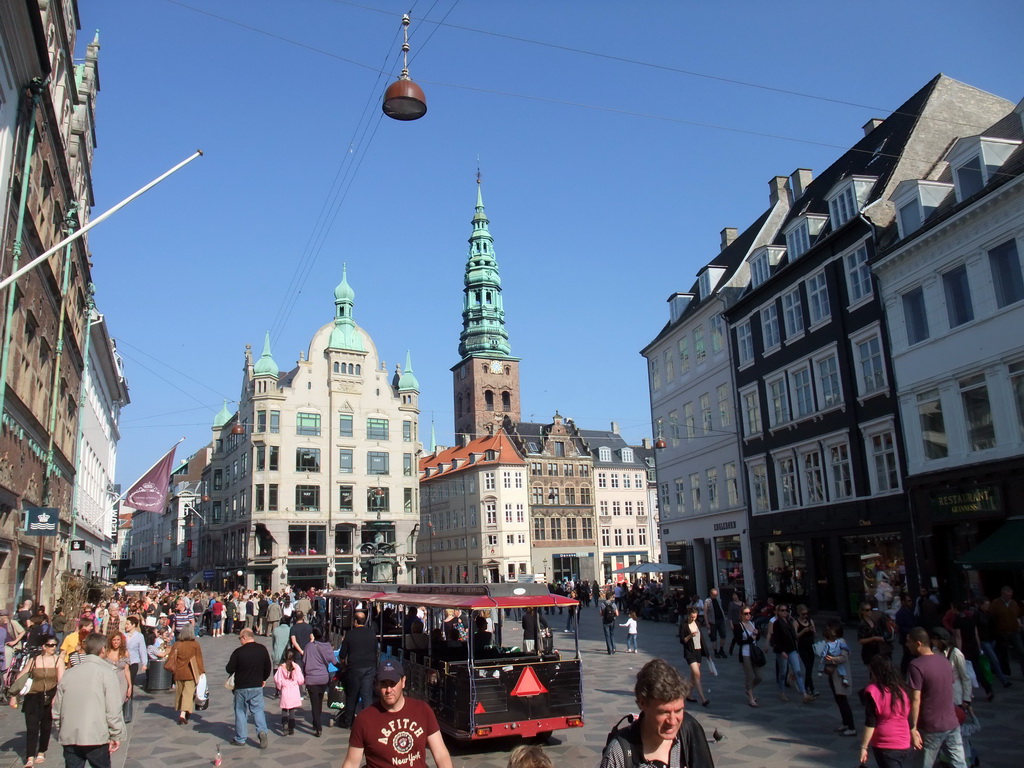 The Amagertorv square with the Stork Fountain, the tower of the Saint Nicholas Church and a tourist train