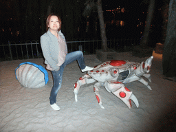 Miaomiao with giant crab at the Tivoli Gardens, by night