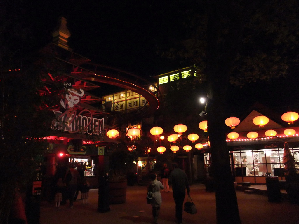 Street with lanterns below the attraction `The Demon` at the Tivoli Gardens, by night