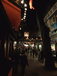 Street with small attractions and shops at the Tivoli Gardens, by night