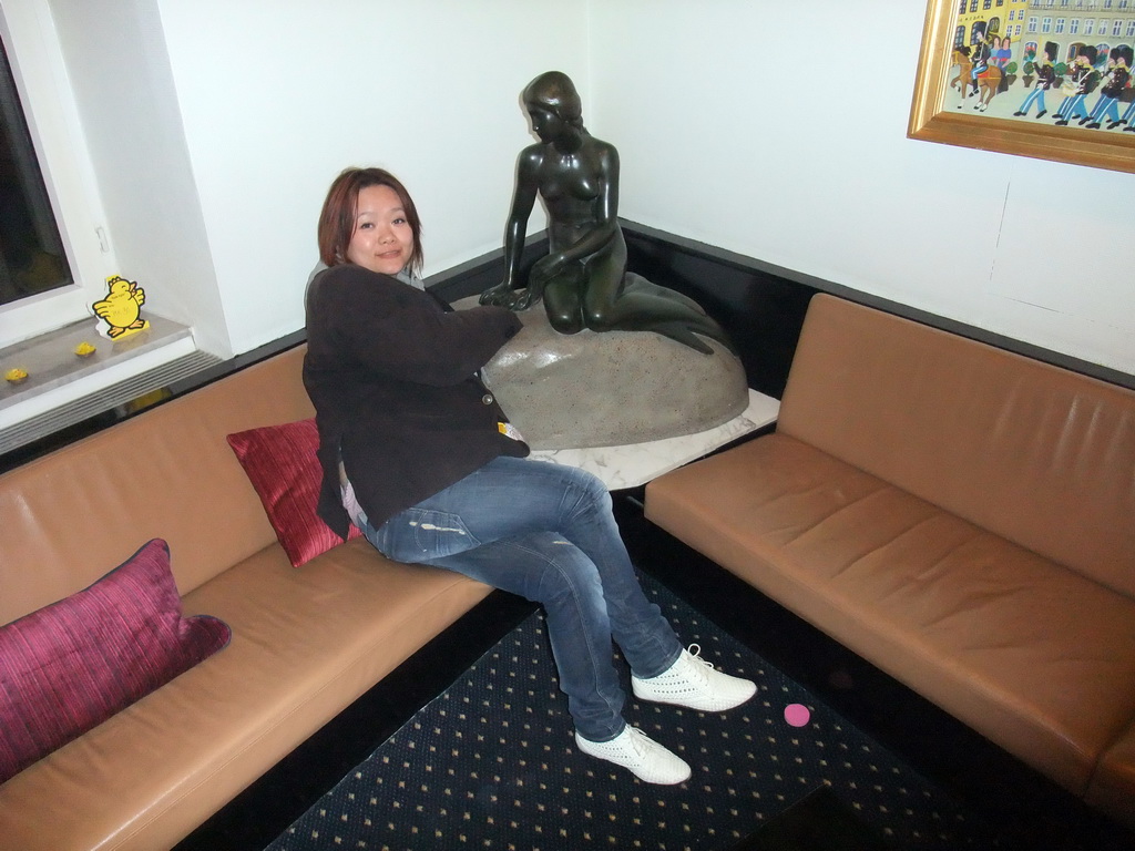 Miaomiao with a copy of the statue `The Little Mermaid` in the lobby of Absalon City Hotel Copenhagen
