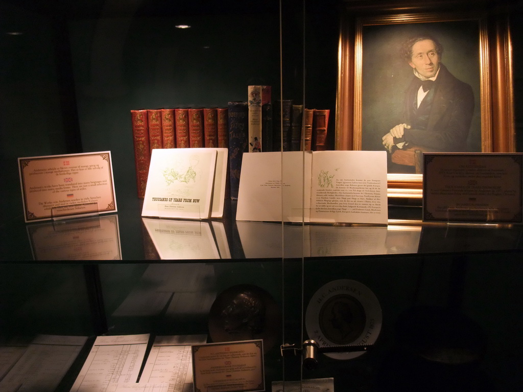 Books and portrait of Hans Christian Andersen in the H.C. Andersen Eventyrhuset museum