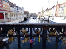 Locks hanging on the Nyhavnsbroen bridge, with a view on the Nyhavn harbour