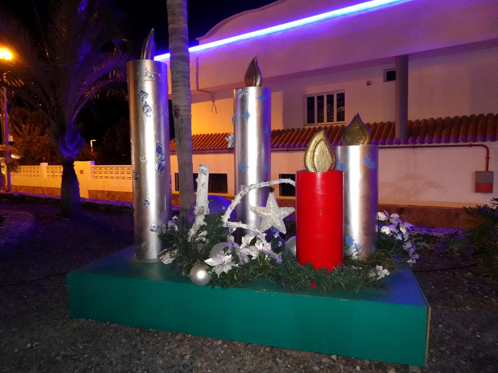 Candle statues at the park at the east side of the Calle El Muelle street, by night