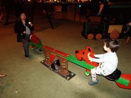 Miaomiao and Max on the seesaw at the playground at the Calle los Pescadores street, by night