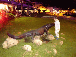 Max with a Komodo Dragon statue at the Calle los Pescadores street, by night