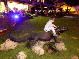 Max with a Komodo Dragon statue at the Calle los Pescadores street, by night