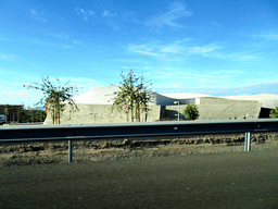 Northeast side of the Magma Art & Congress center, viewed from the rental car on the Autopista del Sur road