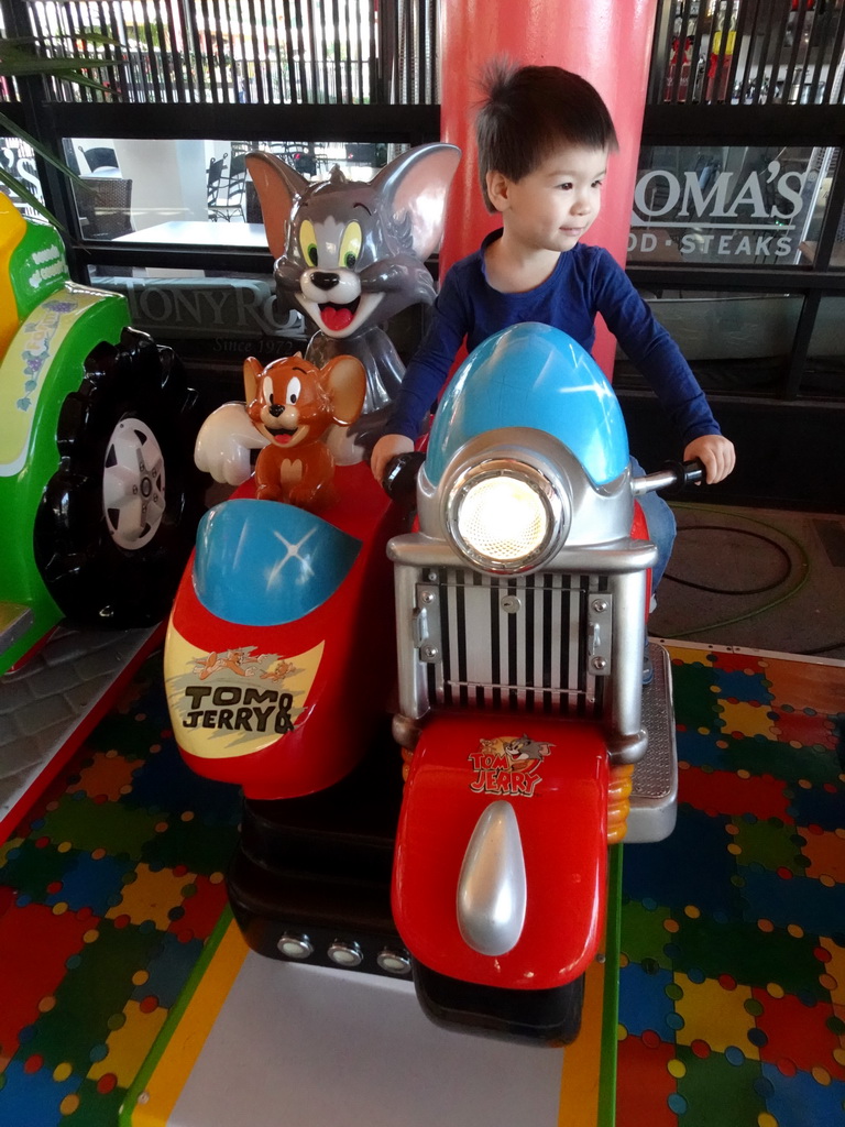 Max on a Tom & Jerry scooter at the upper floor of the Siam Mall