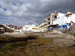 The Playa La Caleta beach and buildings at the Calle El Muelle street
