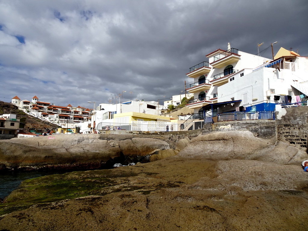 The Playa La Caleta beach and buildings at the Calle El Muelle street