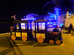 Max on a train at the playground at the Calle los Pescadores street, by night