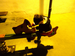 Max on the seesaw at the playground at the Calle los Pescadores street, by night
