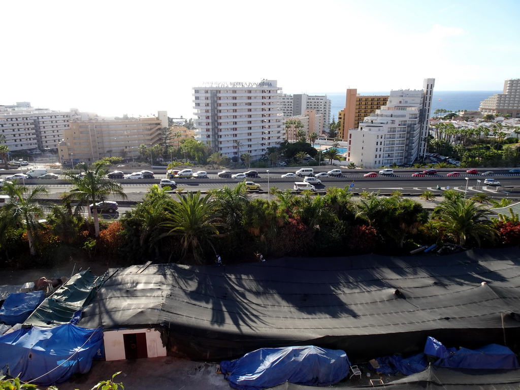 Buildings in the town center and the Autopista del Sur road, viewed from a walking bridge at the Siam Park water theme park