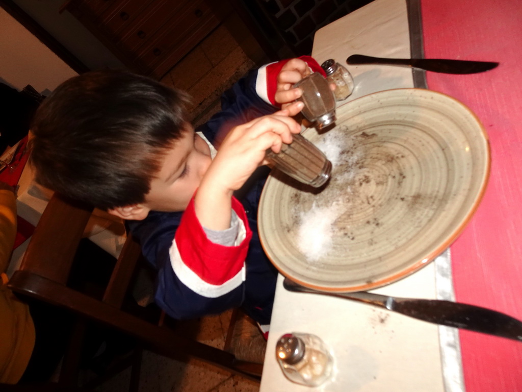 Max playing with pepper and salt at the Paquita Bello restaurant