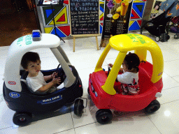 Max and his cousin in toy cars in a shopping mall at Fushun Street