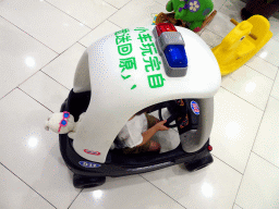 Max in a toy police car in a shopping mall at Fushun Street