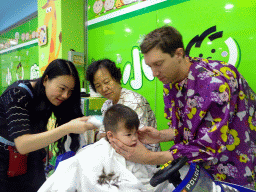 Tim, Max and Miaomiao`s mother at the barber in a shopping mall at Fushun Street