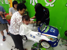 Max and Miaomiao`s mother and sister at the barber in a shopping mall at Fushun Street