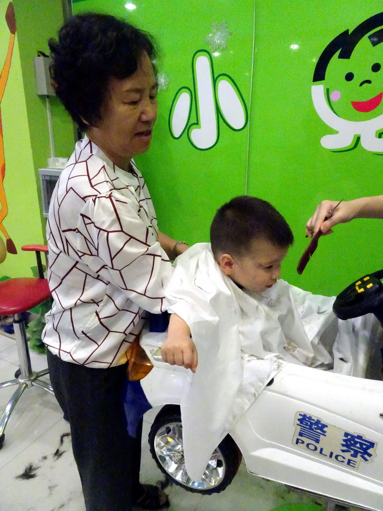 Max and Miaomiao`s mother at the barber in a shopping mall at Fushun Street