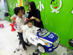 Max and Miaomiao`s mother and sister at the barber in a shopping mall at Fushun Street