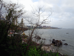 Rock beach just below a square at Binhai Road and skyscrapers at the Xihaitun neighbourhood