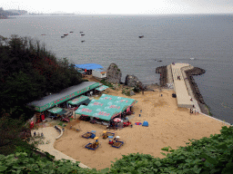 Tents and pier at Haijingyuan beach, viewed from a square at Binhai Road