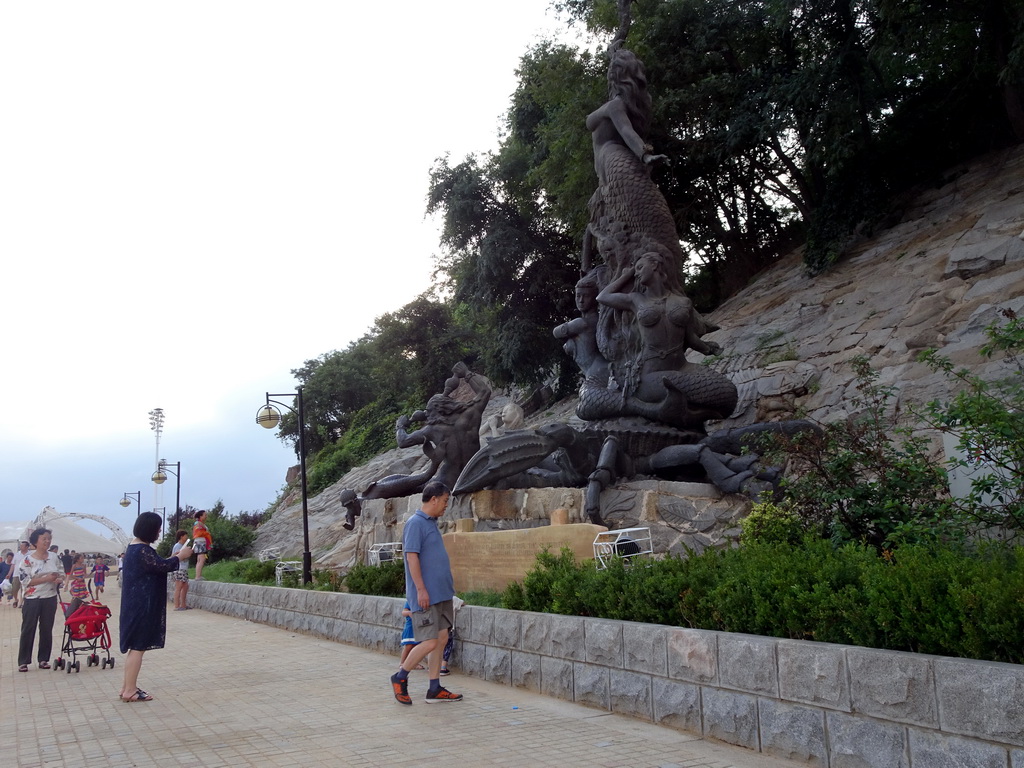 Miaomiao`s family with a Mermaid statue at Haijingyuan beach