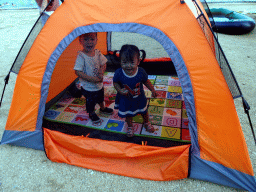 Max and his cousin in a tent at Haijingyuan beach
