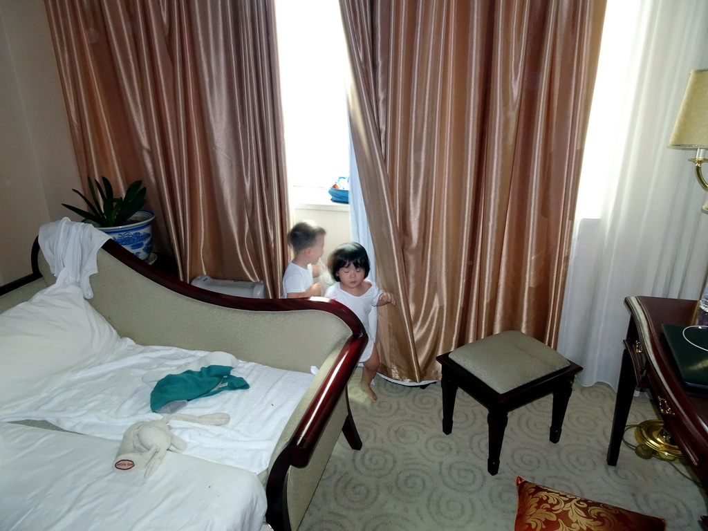 Max and his cousin in our first bedroom at the New Sea View International Hotel