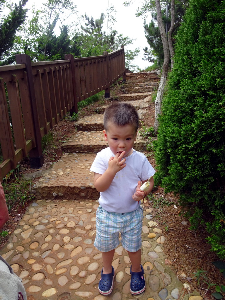 Max on the road from the pavilion to the beach at the Dalian Jinshitan Coastal National Geopark