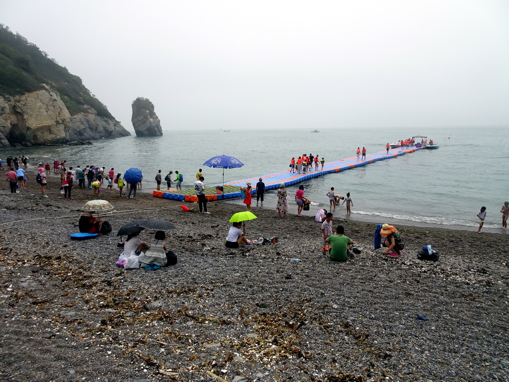 Beach, pier and rock at the Dalian Jinshitan Coastal National Geopark