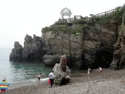 Beach, rock with inscription and pavilion at the Dalian Jinshitan Coastal National Geopark