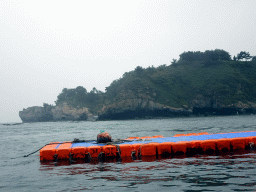 Rocks and pier at the Dalian Jinshitan Coastal National Geopark, viewed from the ferry