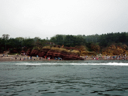 Rocks and beach at the Dalian Jinshitan Coastal National Geopark, viewed from the ferry