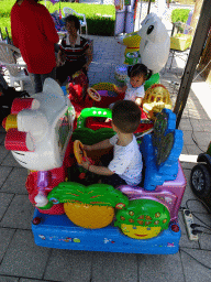 Max with his cousin and grandmother at the toy cars at the playground at Haibin Park