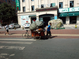 Building and tricycle at Fushun Street, viewed from the taxi