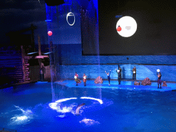 Dolphins and zookeepers in the Main Hall of the Pole Aquarium at the Dalian Laohutan Ocean Park, during the Water Show