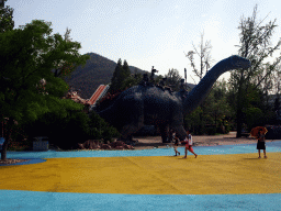 Dinosaur and cavemen statues at the Jurassic Exploration area at the Dalian Laohutan Ocean Park