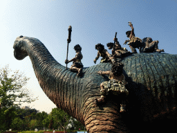 Dinosaur and cavemen statues at the Jurassic Exploration area at the Dalian Laohutan Ocean Park